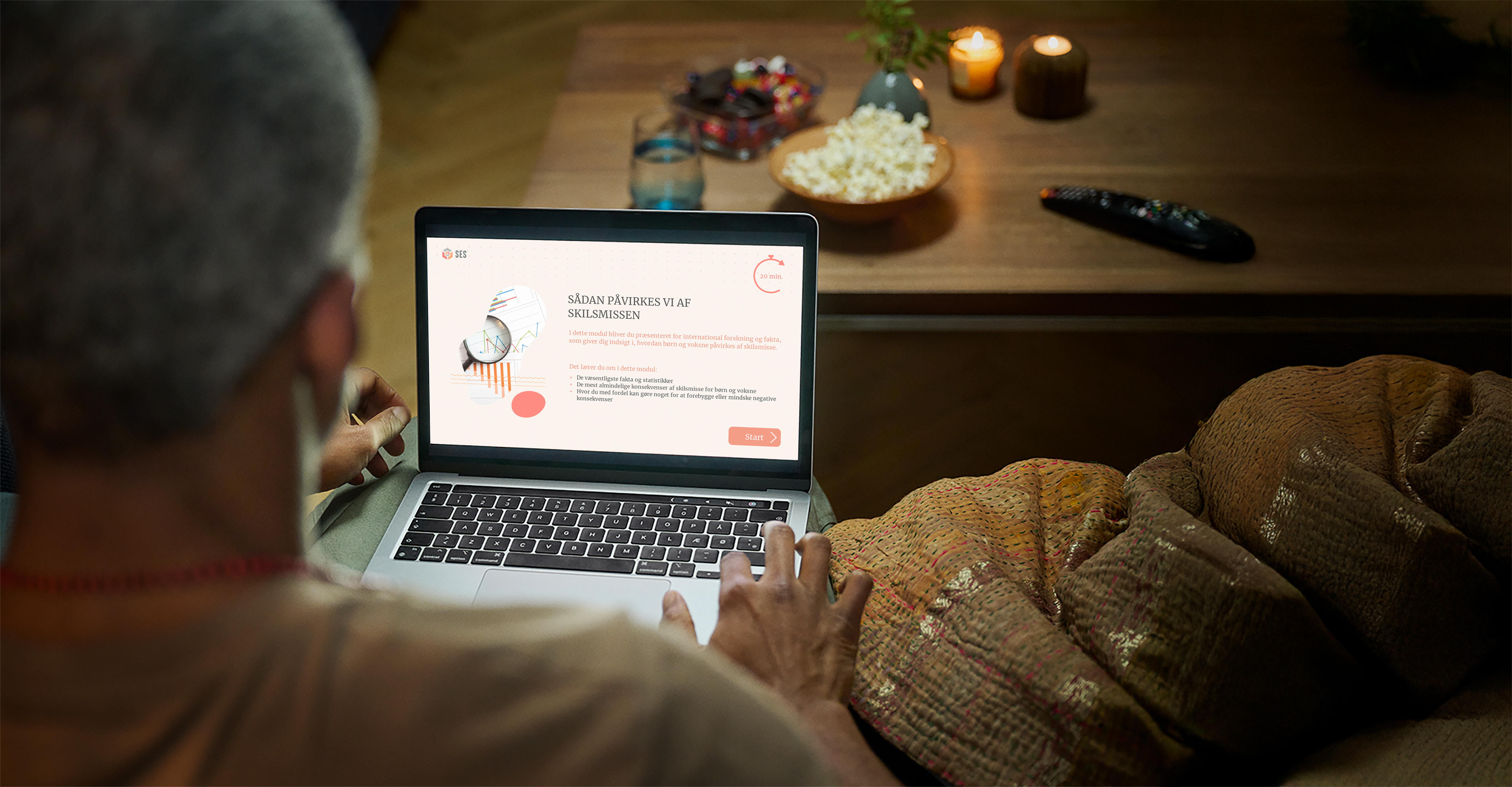 Man sitting on couch using the SES website on a laptop with snacks on the table. 